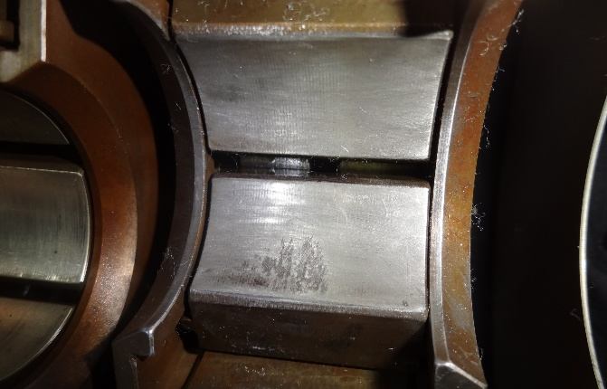 IHI TX-A 1st-stage bearing pad — visible pitting on babbitt surface