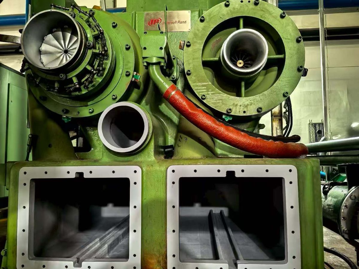 Ingersoll Rand / Cameron TA6000 compressor with casing opened — two stage volutes, impellers and intercooler boxes exposed